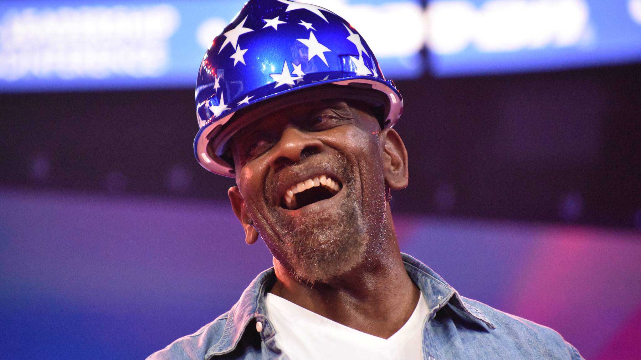 Photo of Chris Gardner wearing a red, white and blue safety helmet.