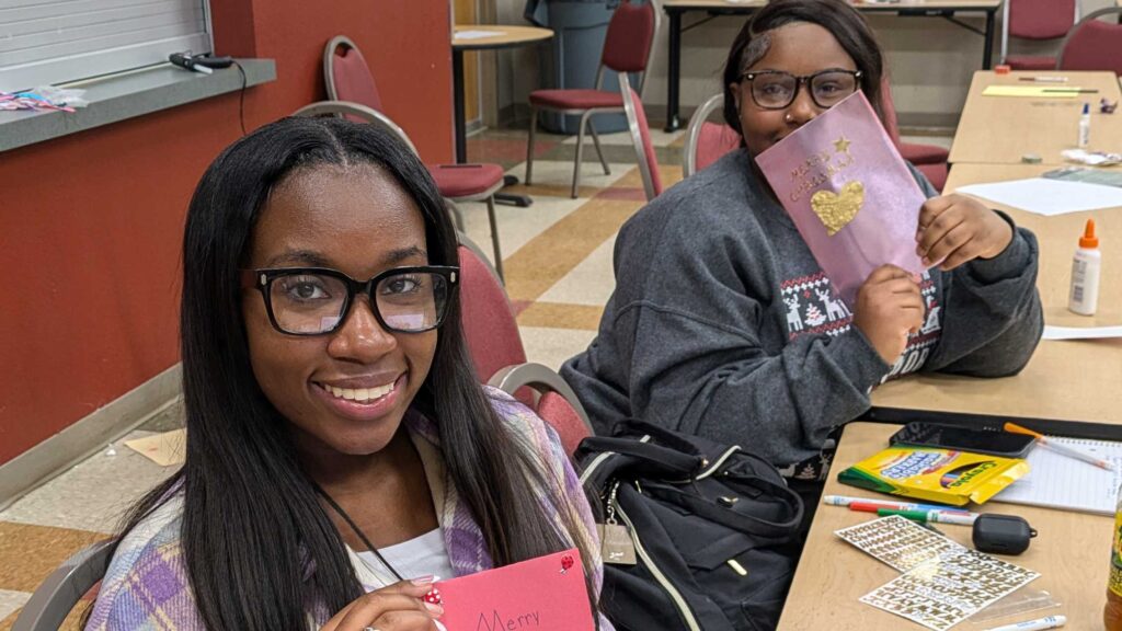 Photo of students holding holiday cards.