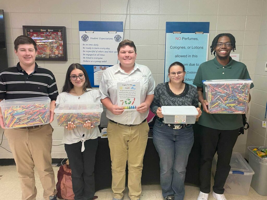 Photo of students with Crayon Collection 1: L to R: Afternoon (p.m.) officers—Taylor Owen, Melina Ramirez, Tanner Dunson, Jolie Rainey, and Ni'Kai Wright.