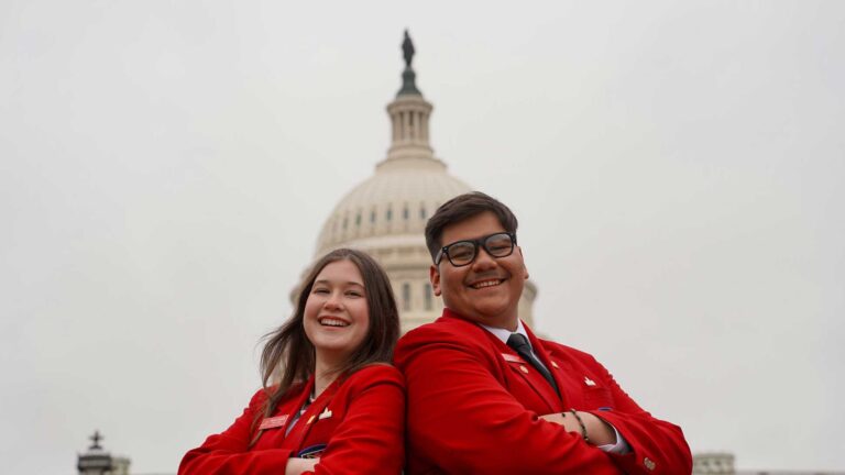 Two students in from of the U.S. Capitol building.