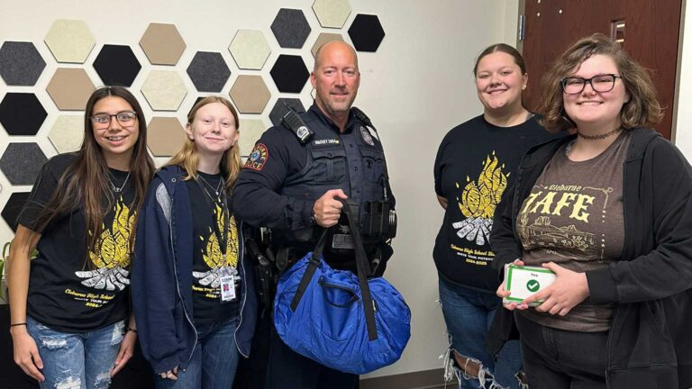 Photo of Cleburne High students and Officer Mackey.