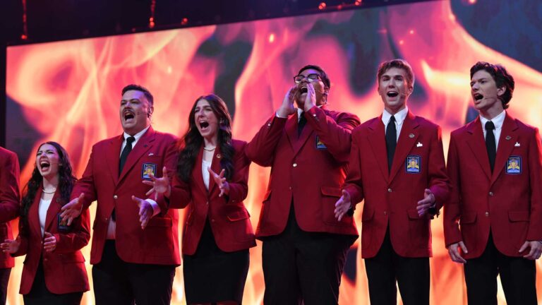 Five SkillsUSA National Officers cheering on stage.