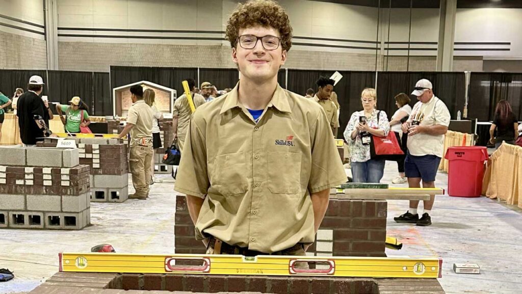 Sam Berryman standing behind his state conference masonry project.