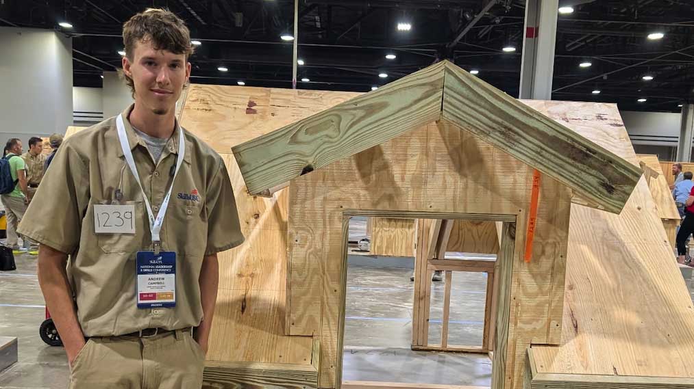 Andrew Campbell poses with his carpentry project.